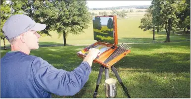  ?? (NWA Democrat-Gazette/Lynn Kutter) ?? Dustin Miller of Siloam Springs paints the valley recently at Prairie Grove Battlefiel­d State Park.