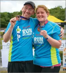  ??  ?? Runners showing off their ‘Run Killarney’ medals at the finish-line on Saturday afternoon.