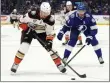  ?? CHRIS O'MEARA — THE ASSOCIATED PRESS ?? Ducks defenseman Cam Fowler carries the puck in front of Lightning center Steven Stamkos on Saturday.