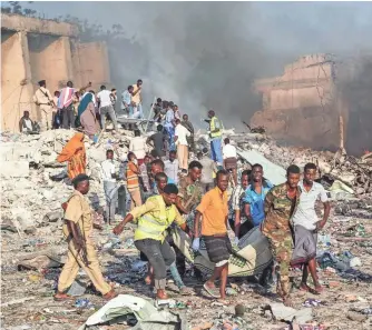  ?? MOHAMED ABDIWAHAB, AFP/GETTY IMAGES ?? A truck bomb in a busy shopping district in Somalia’s capital, Mogadishu, killed more than 350 people Oct. 14, one of the deadliest terror attacks since 9/11.