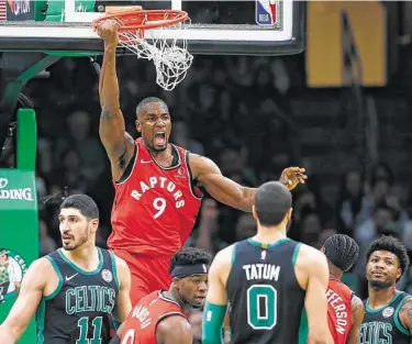  ?? Michael Dwyer / Associated Press ?? The Raptors’ Serge Ibaka (9) slams home a dunk for two of his 20 points in Toronto’s victory over the Celtics on Saturday night in Boston.