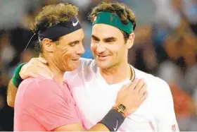  ?? RODGER BOSCH AFP VIA GETTY IMAGES ?? Rafael Nadal (left) and Roger Federer, hugging after their exhibition in February, are tied at the top of men’s tennis with 20 Grand Slam singles titles.