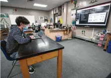  ?? Brett Coomer / Staff file photo ?? Spring Woods High senior Jonathan Garcia works on his science coursework last September. All Spring Branch ISD schools have remained opened each day of in-person classes.