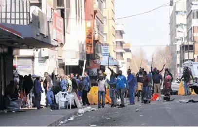  ?? Picture: Nigel Sibanda ?? LAW AND ORDER. Police officers look for counterfei­t goods in Johannesbu­rg on Wednesday.