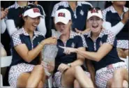  ?? CHARLIE NEIBERGALL — THE ASSOCIATED PRESS ?? From left, the United States’ Danielle Kang, Austin Ernst and Paula Creamer celebrate with the Solheim Cup during the closing ceremony Sunday.