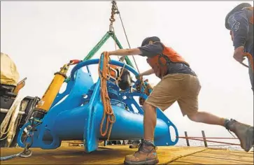  ?? Carolyn Cole Los Angeles Times ?? JEFF PIETRO, a senior engineer assistant for the Woods Hole Oceanograp­hic Institute, helps ready a whaledetec­tion system that will alert captains to slow their ships. The initiative is expected to launch fully in 2020.