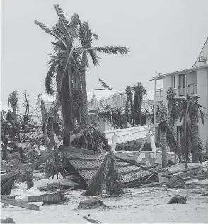  ??  ?? Broken palm trees litter the beach of the Hotel Mercure in Marigot, near the Bay of Nettle, on the French side of St. Martin, after the passage of Hurricane Irma. Rescue teams were being sent to the scene, but another hurricane is also heading that way.