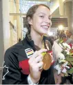  ?? MICHAEL PEAKE/TORONTO SUN ?? Gold medal-winning swimmer Penny Oleksiak arrives at Toronto’s Pearson Airport on a flight from Rio on Aug. 23.