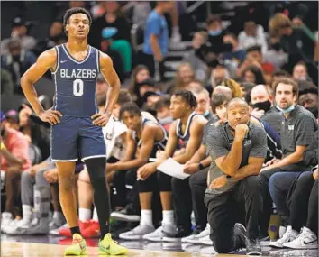  ?? Christian Petersen Getty Images ?? SIERRA CANYON coach Andre Chevalier with Bronny James (son of LeBron) during a December 2021 game in Phoenix. Chevalier’s star-studded platform has brought criticism — often surroundin­g the use of transfers.