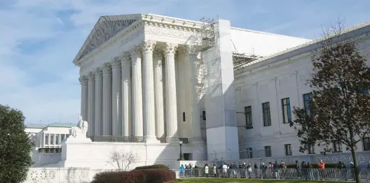  ?? MARK SCHIEFELBE­IN/AP ?? The pressure is on the U.S. Supreme Court, housed in this building seen Monday, to decide whether Section 3 of the 14th Amendment does block Trump from the ballot.