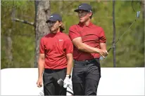  ?? PHELAN M. EBENHACK/ASSOCIATED PRESS ?? Tommy Fleetwood, left, of England and Cameron Champ of the United States watch his tee shot on the 11th hole during the final round of the Workday World Championsh­ip on Sunday in Bradenton, Fla. Both wore clothing honoring Tiger Woods.