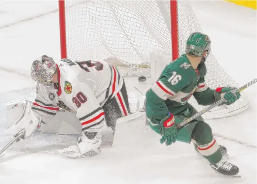  ?? AP ?? The Wild’s Jason Zucker beats Cam Ward on a breakaway in overtime to score the winning goal. The Hawks gave up the tying goal with 23 seconds left in regulation.