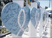  ?? LYNNE SLADKY — THE ASSOCIATED PRESS ?? A wooden heart seen at a makeshift memorial on Wednesday remembers the family of Vishal and Bhavna Patel, who died along with their daughter Aishani, 1, in the collapse of the Champlain Towers South building.