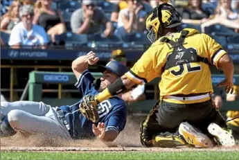  ?? Matt Freed/Post-Gazette ?? Pirates catcher Elias Diaz tags out Padres baserunner Eric Hosmer attempting to steal home in the eighth inning.