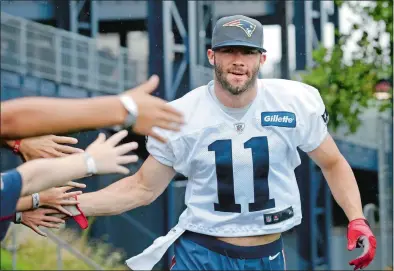  ?? STEVEN SENNE/AP PHOTO ?? In this July 31, 2016, file photo, New England Patriots wide receiver Julian Edelman greets fans as he steps on the field before a training camp practice in Foxborough, Mass.