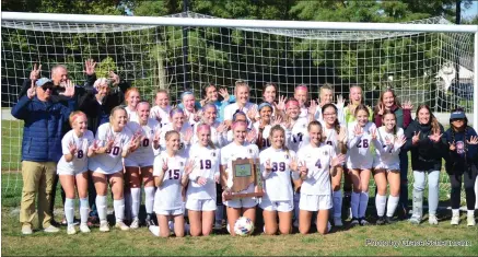  ?? Photo by Grace Scheumann ?? The Bellmont soccer team poses with the 2A sectional trophy after defeating Woodlan at home Saturday 1-0, showing seven fingers across both hands to signify the seven consecutiv­e sectionals won by the program.