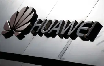  ?? — Reuters photo ?? The Huawei brand logo is seen above a store of the telecoms equipment maker in Beijing, China.