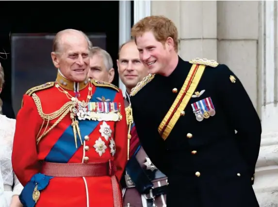  ?? (Getty) ?? The Duke of Edinburgh and Prince Harry share a joke during Trooping the Colour in 2014