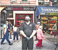  ??  ?? Frank Tuttolomon­do who runs Mama’s Too, poses for a portrait outside the pizzeria’s location on Manhattan’s Upper West Side.