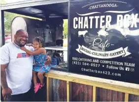  ?? STAFF PHOTO BY MARK KENNEDY ?? Brandon Ellis and his 2-year-old daughter, Harper, are pictured by Ellis’ Chatter Box barbecue truck.