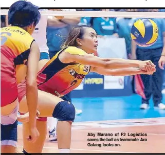  ??  ?? Aby Marano of F2 Logistics saves the ball as teammate Ara Galang looks on.