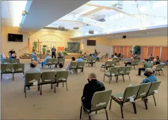  ?? PHOTO VINCENT OSUNA ?? El Centro Fire Department Fire Chief Kenneth Herbert (front stage) listens as an audience member speaks during a COVID-19 informatio­nal meeting for places of worship on May 6, 2020, in El Centro.