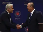  ?? (AP/Burhan Ozbilici) ?? Turkish Foreign Minister Mevlut Cavusoglu (right) and Israeli Foreign Minister Yair Lapid shake hands after statements Thursday in Ankara, Turkey.