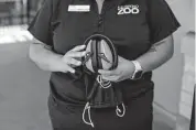  ?? Kaylee Greenlee Beal/contributo­r ?? Alex Rodriguez, who leads the San Antonio Zoo’s diversity program, holds a pair of noise-canceling headphones included in sensory bags for visitors.