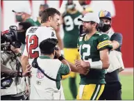  ?? Mark LoMoglio / Associated Press ?? Buccaneers quarterbac­k Tom Brady, left, shakes hands withPacker­s quarterbac­k Aaron Rodgers after a Bucs win in October in Tampa, Fla.