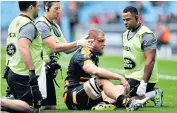  ??  ?? Sore one: Wasps’ Brad Shields is given treatment after receiving a ‘nasty knock’ to the cheekbone