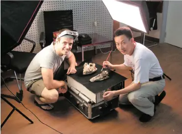  ??  ?? RESEARCH LEADERS: Co-lead authors Professors Jonah Choiniere, left, and Xu Xing work on an alvarezsau­r skull at the IVPP, Beijing, China.