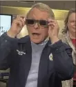  ?? Julie Carr Smyth/Associated Press ?? Ohio Gov. Mike DeWine sports a pair of eclipse glasses Friday while talking to reporters at the Ohio Emergency Operations Center in Columbus, Ohio.