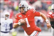  ?? Jay LaPrete / Associated Press ?? Ohio State quarterbac­k Justin Fields plays against Penn State in Columbus, Ohio. Fields was selected to The Associated Press AllBig Ten Conference football team, and named Big Ten Offensive Player of the Year.