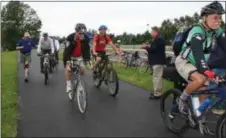  ?? MID-HUDSON NEWS NETWORK PHOTO ?? The new 1 1⁄4-mile paved portion of the Hudson Valley Rail Trail in the town of Lloyd opened Friday with Ulster County officials and bikers on what will eventually be part of the statewide Empire Trail.