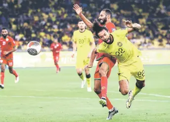  ?? — Bernama photo ?? Malaysia’s Corbin Ong is tackled by an Oman player inside the box during the match.