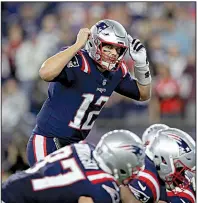  ?? AP/CHARLES KRUPA ?? New England Patriots quarterbac­k Tom Brady calls signals at the line of scrimmage during the first half Thursday against the Indianapol­is Colts in Foxborough, Mass. Brady reached 500 touchdown passes as the Patriots beat the Colts 38-24 for their second consecutiv­e victory.