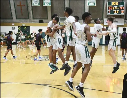  ?? PHOTOS BY CHRIS RILEY — TIMES-HERALD ?? St. Patrick-St. Vincent High’s boys basketball team celebrates its win over St. Joe’s in the North Coast Section Division III Playoffs on Tuesday at the Bruins Lair.