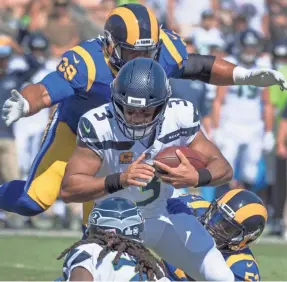  ?? USA TODAY SPORTS / ROBERT HANASHIRO ?? Los Angeles Rams defensive tackle Aaron Donald brings down Seattle Seahawks quarterbac­k Russell Wilson for a sack.