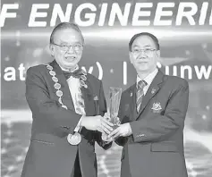  ??  ?? EM President David Lai Kong Phooi presenting the award to Chuah.