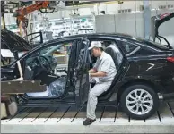  ?? PROVIDED TO CHINA DAILY ?? A worker on the production line of Dongfeng Motor Corp in Guangzhou, capital of Guangdong province.