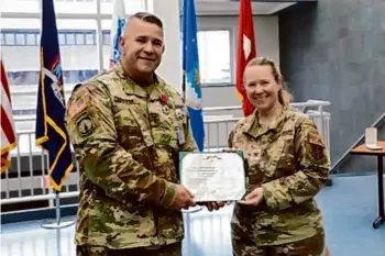  ?? Photos courtesy New York Army National Guard ?? New York Army National Guard Chief Warrant Officer 4 Larry Langley receives a Legion of Merit citation from Col. Michelle Buonome in Latham.