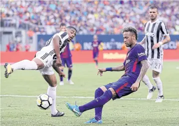  ?? AFP ?? Barcelona’s Neymar takes a shot as Juventus’ Mario Lemina defends during the match at MetLife Stadium in New Jersey.