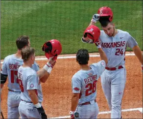  ?? Associated Press ?? Homered: Arkansas' Chad Spanberger (24) celebrates with teammates after hitting a home run against Florida during the first inning of a game in the Southeaste­rn Conference NCAA college baseball tournament, Saturday, in Hoover, Ala.