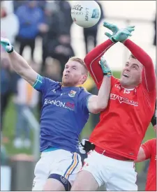  ??  ?? Longford’s Shane Donohoe goes up against Louth’s Andy McDonnell.