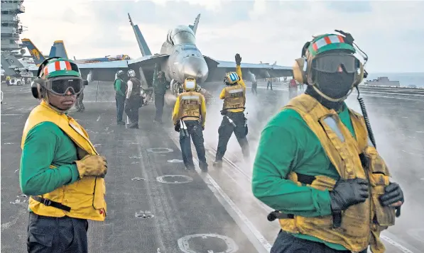  ??  ?? Crew on board the USS Carl Vinson carry out flight operations in the South China Sea after the aircraft carrier and three other American warships were ordered to the West Pacific in a statement of displeasur­e with Pyongyang