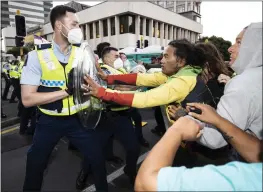  ?? GEORGE HEARD — NEW ZEALAND HERALD VIA AP ?? Police and protesters clash in Wellington, New Zealand, on Tuesday.