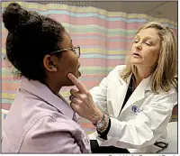  ?? Special to the Democrat-Gazette Dr. Stacie Jones checks over 17-year-old Carre’ Sadler, who suffers from a peanut allergy, during an examinatio­n at Arkansas Children’s Hospital in Little Rock. ??