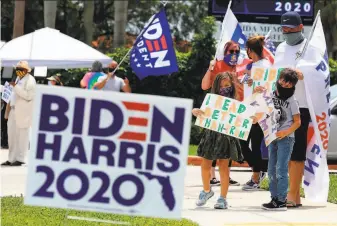  ?? Mike Stocker / South Florida Sun Sentinel ?? Robert McKnight and his children wait for the arrival of Democratic vice presidenti­al candidate Kamala Harris last Thursday at Florida Memorial University in Miami Gardens.