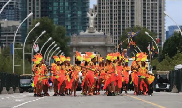  ??  ?? The Vak Band arrives near the Princes’ Gates. Parade participan­ts still had a great time despite cool, blustery weather at the Caribbean Carnival Grande Parade Saturday.