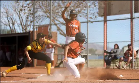  ?? Ellen Schmidt Las Vegas Review-journal @ellenschmi­dttt ?? Clark pitcher Noel Gregorich tries to tag Legacy’s Cassandra Arellano as she slides in safely at home during Wednesday’s game. Legacy scored 12 runs in the first inning, and the Longhorns went on to a 17-2 home win.